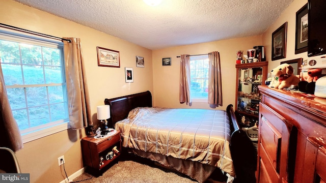 carpeted bedroom featuring a textured ceiling