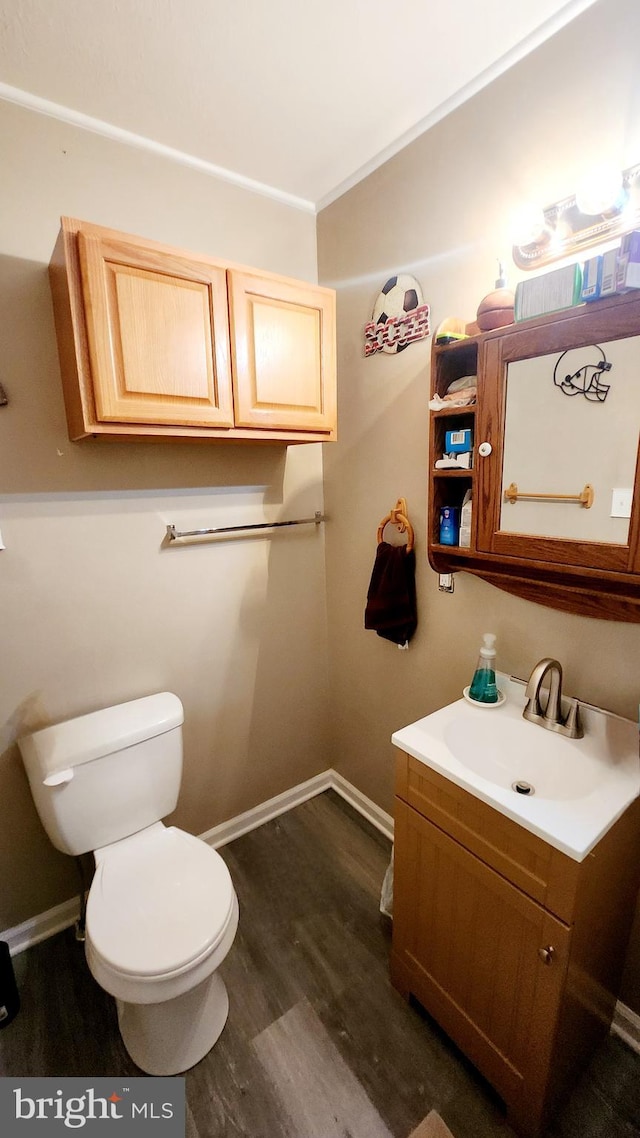 bathroom featuring hardwood / wood-style floors, vanity, and toilet