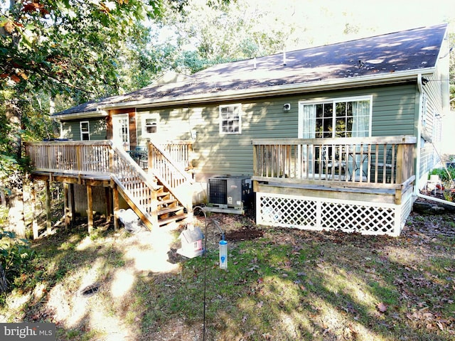 rear view of property with central AC unit and a deck