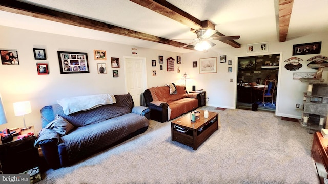 carpeted living room with ceiling fan and beam ceiling