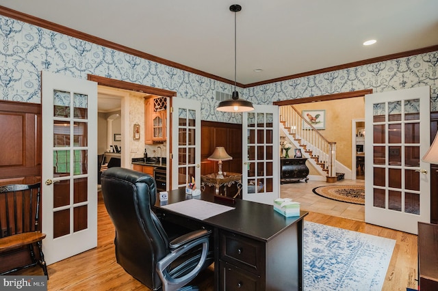 office space with ornamental molding, french doors, and light wood-type flooring