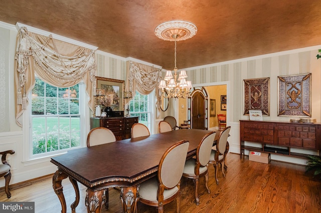 dining area with an inviting chandelier and hardwood / wood-style flooring