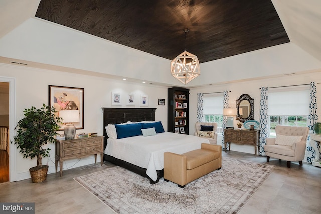 bedroom featuring a tray ceiling, an inviting chandelier, and wooden ceiling