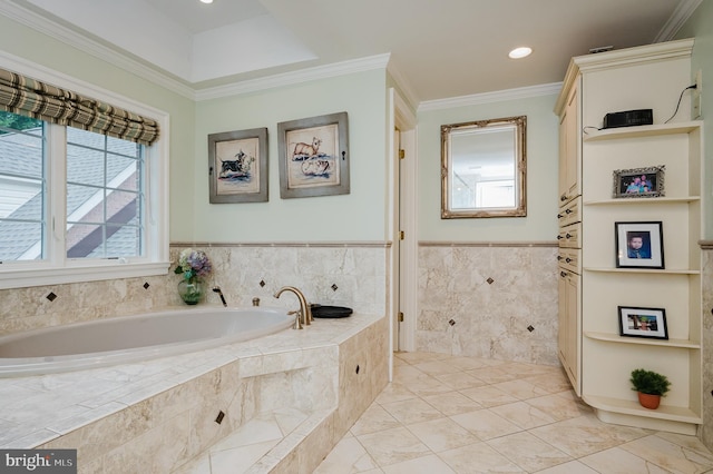 bathroom with crown molding and a relaxing tiled tub