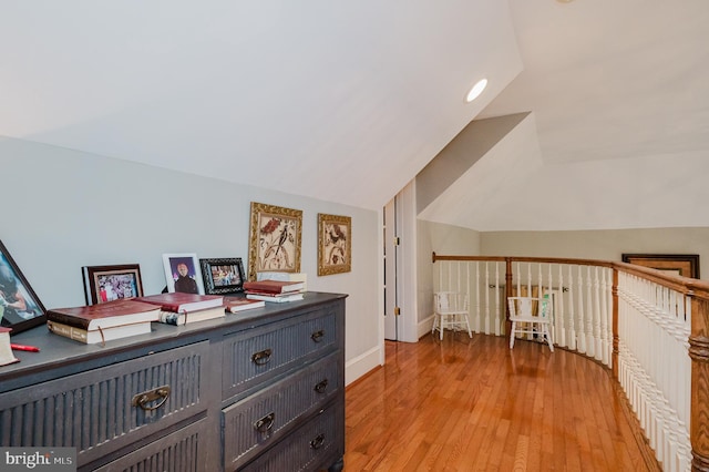 bedroom featuring lofted ceiling and light wood-type flooring