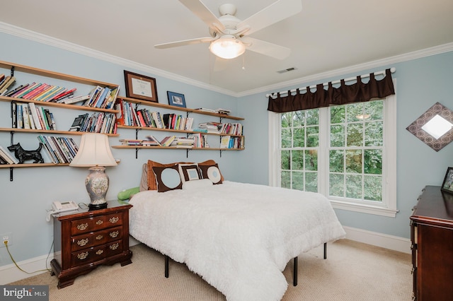 carpeted bedroom with ceiling fan and crown molding