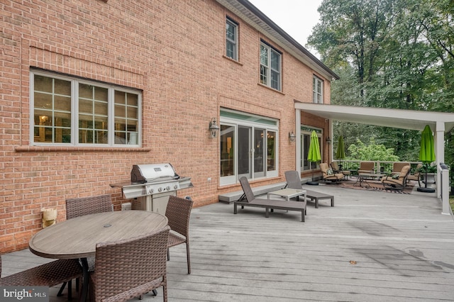 wooden terrace with a grill