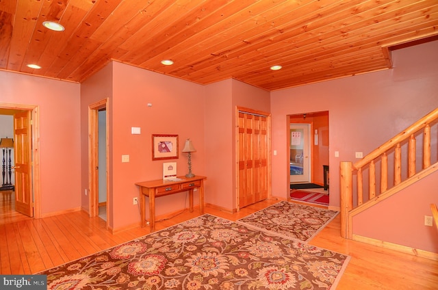 entryway featuring light wood-type flooring and wood ceiling