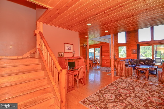 staircase featuring hardwood / wood-style floors and wooden ceiling