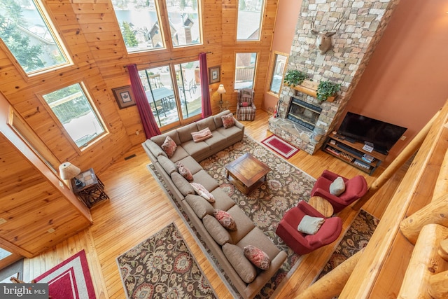 79 Cedar Shores Dr, Mc Henry, MD 21541 - living area featuring a towering ceiling, wooden walls, a fireplace, and wood finished floors