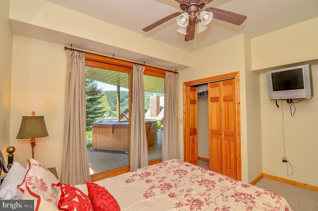 carpeted bedroom with ceiling fan and a closet