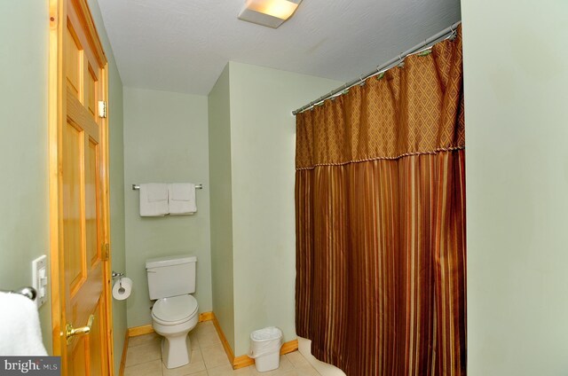 bathroom featuring tile patterned flooring and toilet