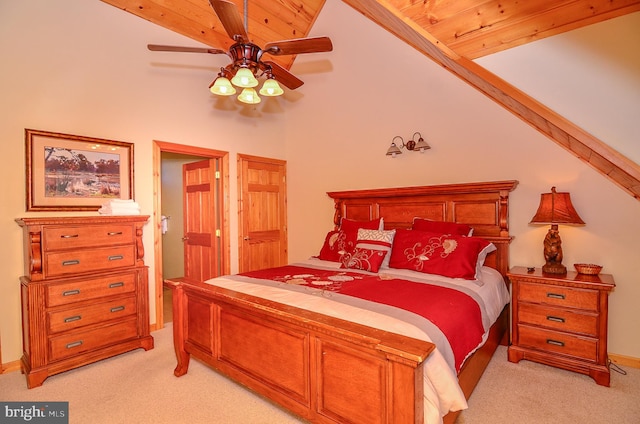 carpeted bedroom with high vaulted ceiling, ceiling fan, and wooden ceiling