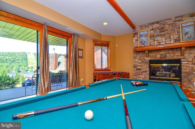 recreation room with a fireplace and pool table