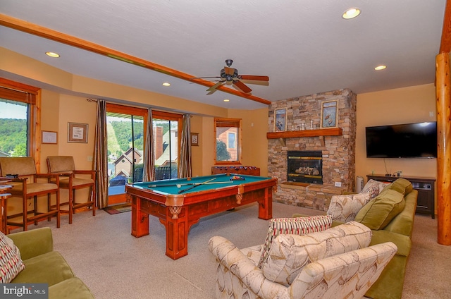 playroom featuring pool table, ceiling fan, plenty of natural light, and a stone fireplace