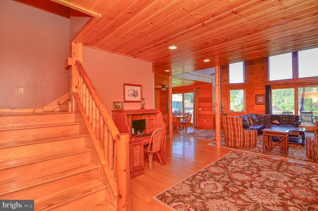 staircase featuring wooden ceiling and hardwood / wood-style flooring