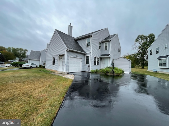 view of front of house with a garage and a front lawn