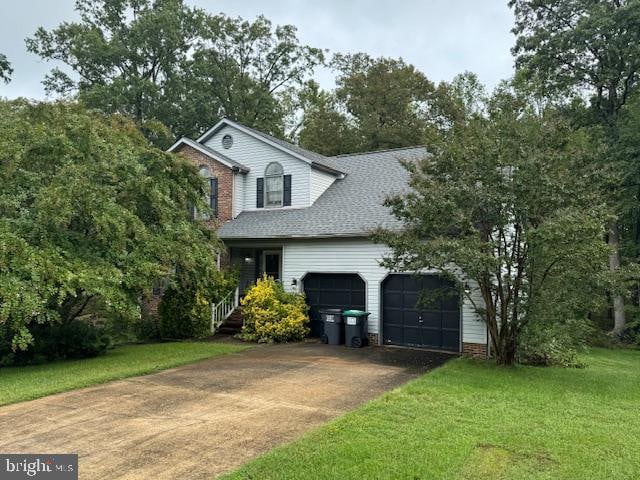 view of front of home with a front yard and a garage