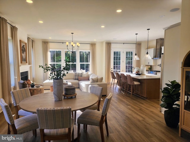 dining room with a chandelier, french doors, and dark wood-type flooring