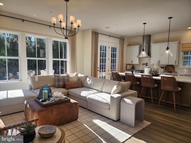 living room featuring light wood-type flooring and a notable chandelier