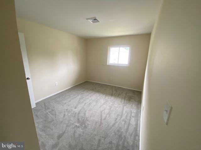 spare room featuring carpet floors