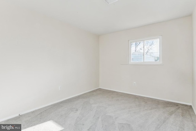 empty room featuring light carpet