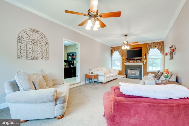 carpeted living room with ornamental molding and ceiling fan