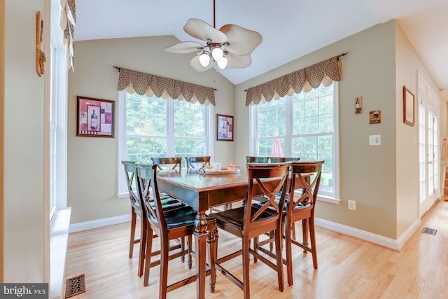 dining area with light wood-type flooring, lofted ceiling, and ceiling fan