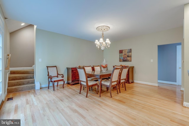 dining room with a notable chandelier and light hardwood / wood-style flooring