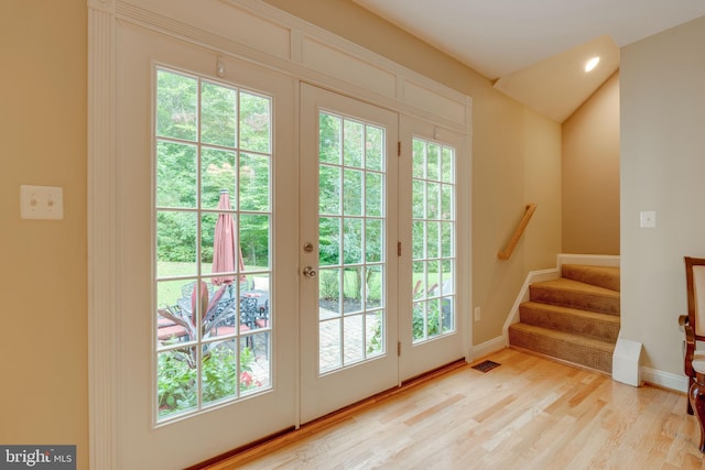 doorway to outside with a wealth of natural light and light hardwood / wood-style floors