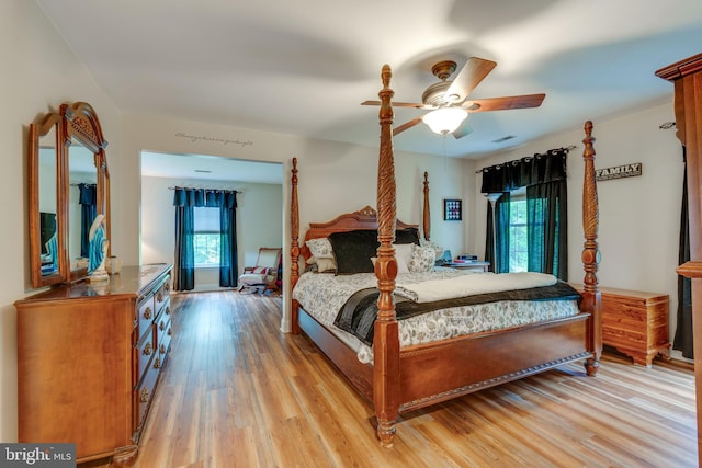 bedroom with light hardwood / wood-style floors and ceiling fan