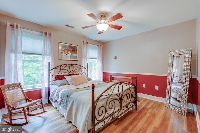 bedroom with light wood-type flooring and ceiling fan