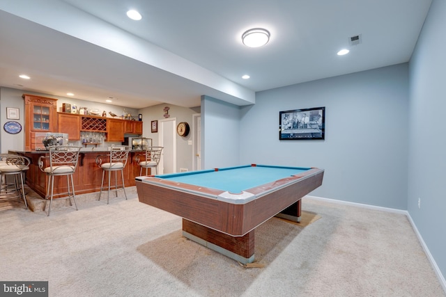 rec room featuring light carpet, indoor bar, and pool table