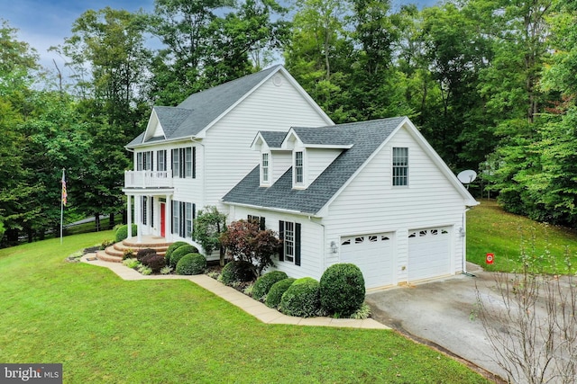 view of front of home with a garage and a front lawn