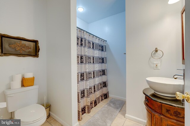 bathroom with walk in shower, tile patterned flooring, vanity, and toilet