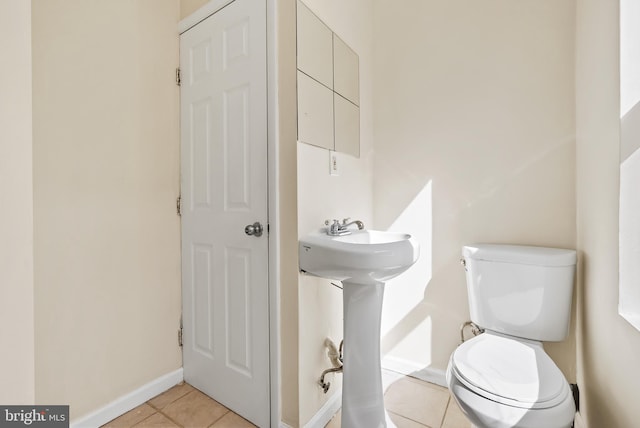 bathroom featuring tile patterned flooring and toilet