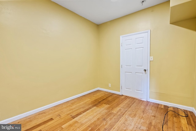 empty room with hardwood / wood-style floors