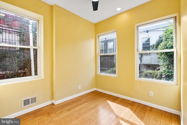 empty room with ceiling fan, light hardwood / wood-style flooring, and a wealth of natural light