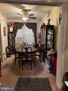 carpeted dining area featuring ceiling fan