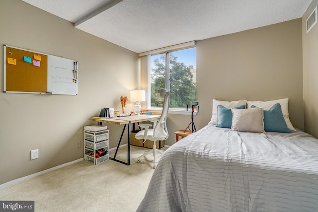 carpeted bedroom featuring a textured ceiling