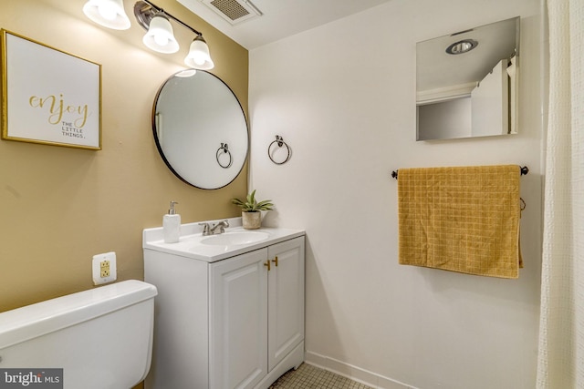 bathroom featuring tile patterned flooring, vanity, and toilet