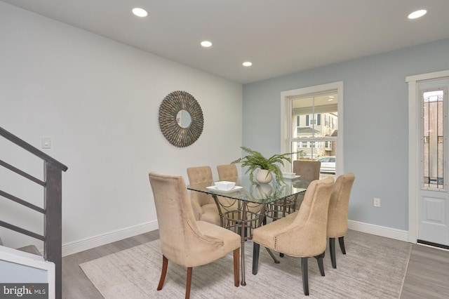 dining area with plenty of natural light and hardwood / wood-style floors