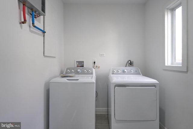 clothes washing area featuring separate washer and dryer