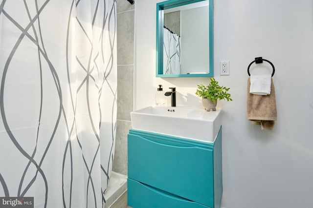 bathroom featuring vanity and curtained shower