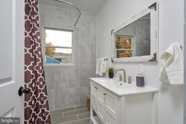 bathroom with a shower with curtain, vanity, and hardwood / wood-style floors