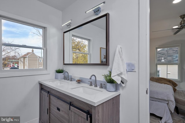 bathroom with ceiling fan and vanity