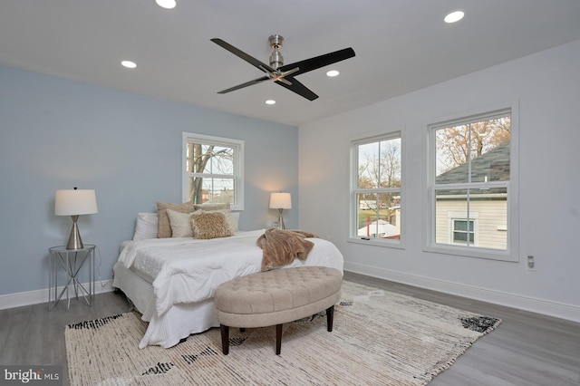 bedroom with ceiling fan and hardwood / wood-style flooring