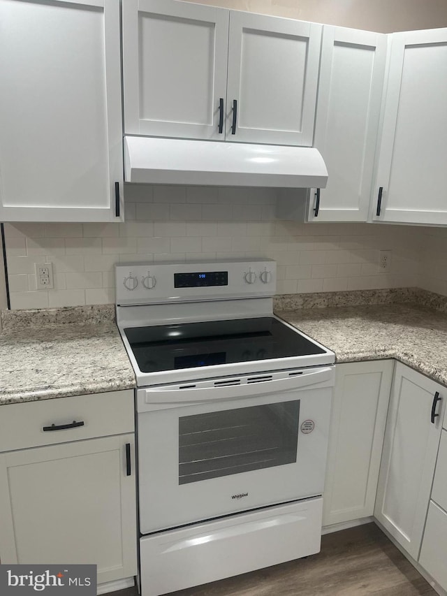 kitchen with hardwood / wood-style flooring, white electric stove, white cabinetry, light stone counters, and tasteful backsplash