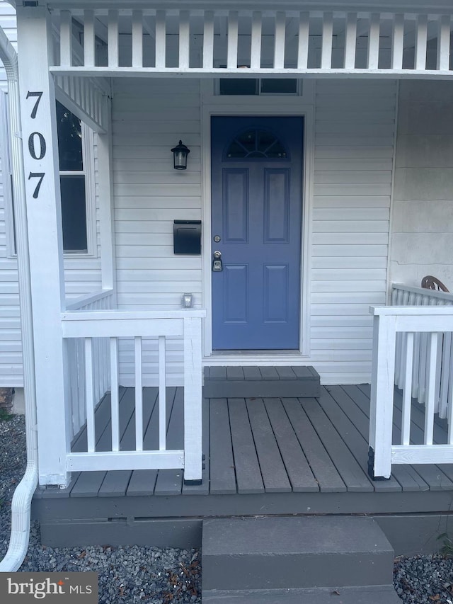 view of exterior entry featuring a porch