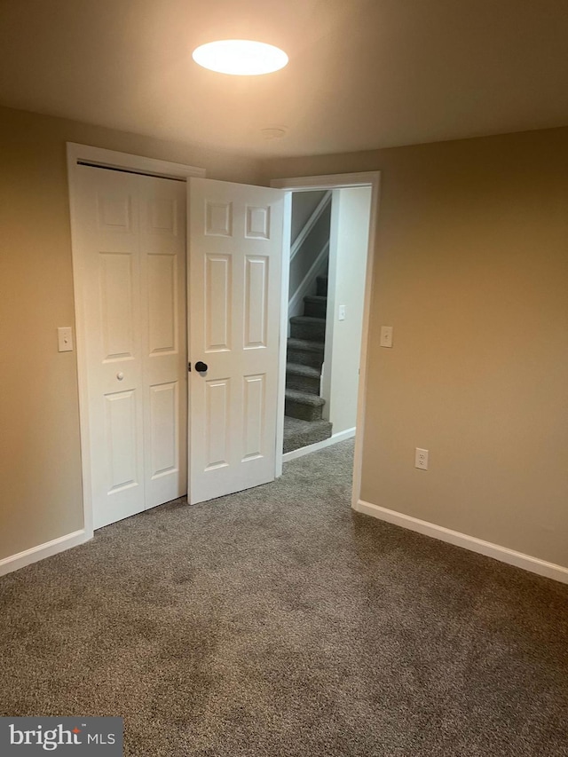 unfurnished bedroom featuring a closet and carpet floors